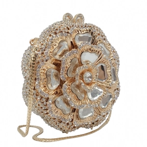 Macro detail of the luxury rose-shaped clutch with golden hollow petals and sparkling crystals