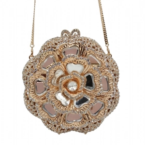 Detail of champagne gold floral clutch with sparkling crystals and drop-shaped pink gems