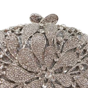 Detail of silver rhinestone evening bag featuring intricate floral crystal patterns