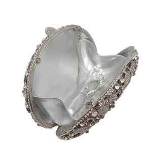 Macro view of silver rhinestone evening bag interior with satin lining and chain