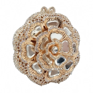 Detailed macro of flower-shaped evening clutch featuring intricate crystal paving and metal bud clasp