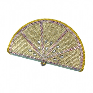 Detail shot of lemon slice evening clutch with vibrant gold and pink rhinestones
