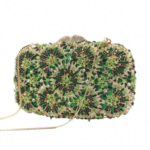 Detailed macro view of the sparkling green and white rhinestones on the evening clutch