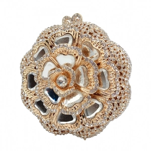 Detail of flower shaped evening clutch with sparkling rhinestones and crystal center