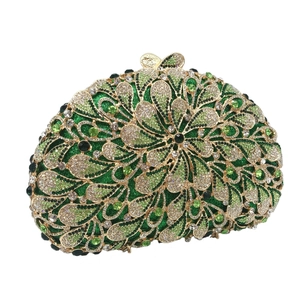 Detail of luxury emerald green evening bag with gold floral hollow lace and crystals