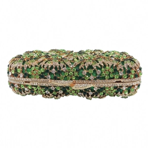 Detailed macro view of an evening clutch bag featuring green floral rhinestone patterns