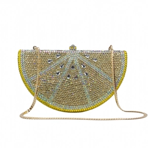 Detailed view of the sparkling lemon rhinestone evening clutch with crystal buckle and chain