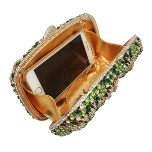 Luxurious rhinestone evening clutch with gold metal frame showing phone capacity inside