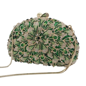 Detail of green rhinestone evening bag showing floral pattern and gold metal frame