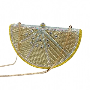 Detail showing lemon-shaped evening clutch with gold rhinestones and crystal drop accents