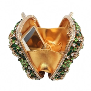 Hollow out metal evening clutch with green and white rhinestones and a gold chain strap