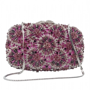 Detail of luxury evening clutch bag featuring radiant pink and purple crystal sunflower pattern