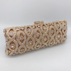 Detailed close-up of hollow metal clutch with sparkling gold and clear rhinestones