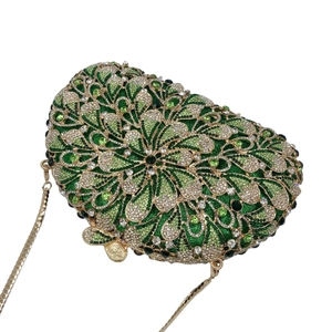 Detail of green floral rhinestone clutch bag with gold chain and luxury crystal texture
