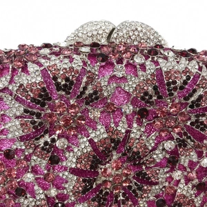 Macro detail of luxury evening clutch featuring radiant pink crystals and floral rhinestone patterns