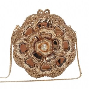 Detailed macro view of golden floral evening bag with sparkling crystals and amber gems