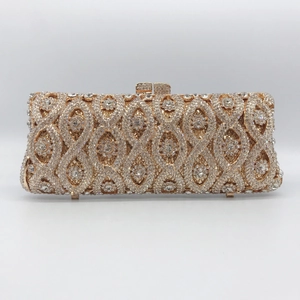 Detail of evening clutch featuring geometric crystal pattern and gold metal frame