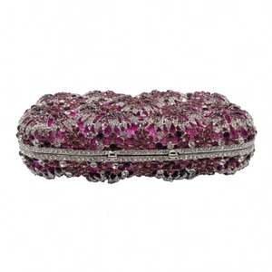 Macro detail of wave pattern purple and silver rhinestones on luxury dinner clutch bag