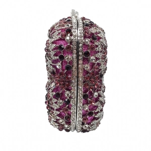 Close-up of floral crystal patterns on a magenta rhinestone evening clutch bag