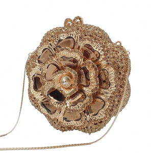 Detailed view of luxury gold rose evening bag with amber crystals and metal snake chain