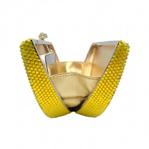 Detailed view of yellow crystal heart evening clutch with golden leather lining