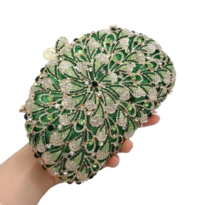 Detailed macro view of green floral rhinestone evening bag with elegant golden clasp