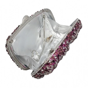Detailed interior of luxury cat-shaped evening bag with pink crystals and silver chain