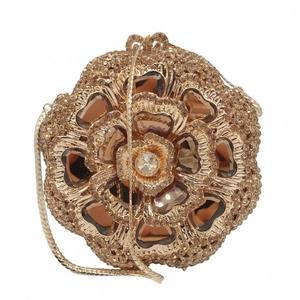 Macro detail of champagne gold floral evening bag with rhinestones and snake chain