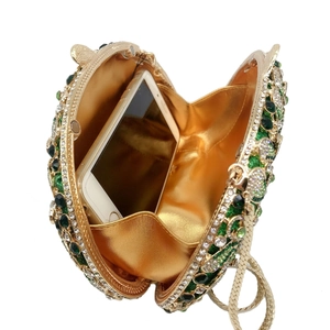 Detailed interior view of a luxury rhinestone evening clutch showing phone storage capacity