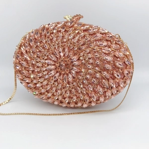 Elegant champagne crystal oval evening clutch bag with gold metal frame and bird clasp