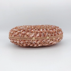 Pink rhinestone encrusted oval evening clutch bag with gold-tone metal frame