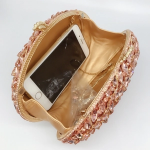 Pink gold crystal clutch evening bag with metal frame and chain showing interior capacity
