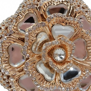 Macro detail of golden hollow floral evening bag with rhinestones and heart gemstones