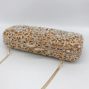 Macro detail of gold metal frame and sparkling crystal rhinestones on dinner clutch