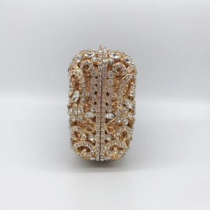 Detail of hollow metal evening clutch with shimmering rhinestones and floral patterns
