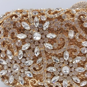 Macro detail of luxury evening clutch featuring intricate floral patterns in crystal diamonds