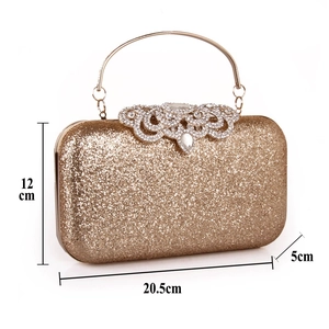 Detailed size view of a gold sequin evening clutch with rhinestone buckle and metal handle