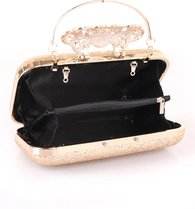 Macro view of gold sequin evening clutch bag with black lining and metal frame