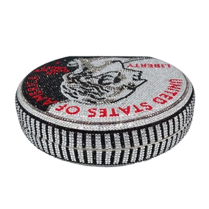 Detailed close-up of dollar coin pattern on round evening bag with shiny rhinestones