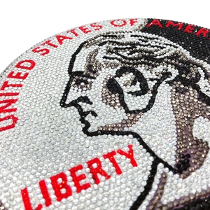Macro view of crystal rhinestones forming a US 25-cent coin pattern on a round evening bag