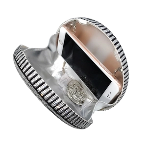 Round evening clutch bag with black and white crystal stripes and silver chain strap