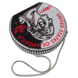 Macro shot of circular evening bag with Liberty coin rhinestone pattern and silver chain