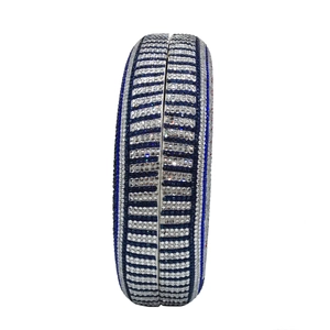 Close-up of the striped rhinestone pattern on a circular evening clutch bag