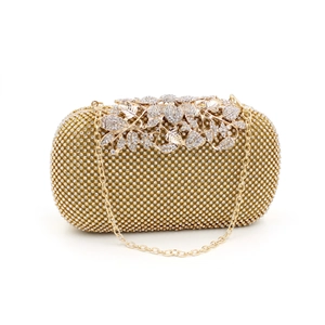 Detailed view of luxury gold clutch with crystal mesh and floral diamond clasp