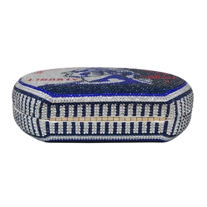 Close-up of red and blue rhinestone evening bag with premium golden metal hinge detail