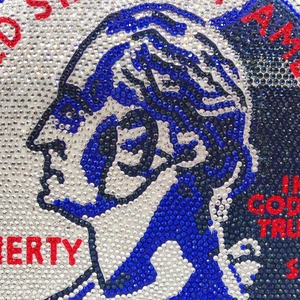 Macro detail of luxury rhinestone evening bag with Liberty coin pattern and crystals