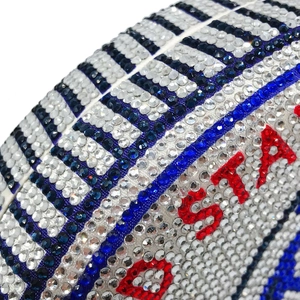 Macro detail of luxury rugby evening bag featuring sparkling red and blue rhinestones