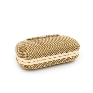 Close-up of sparkling crystal rhinestones and golden metal frame on evening clutch bag