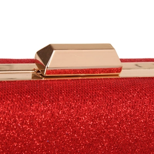 Close-up of the gold metal clasp and red glitter texture on the evening clutch bag
