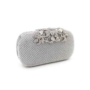 Detailed view of silver crystal evening clutch with leaf and flower rhinestone clasp